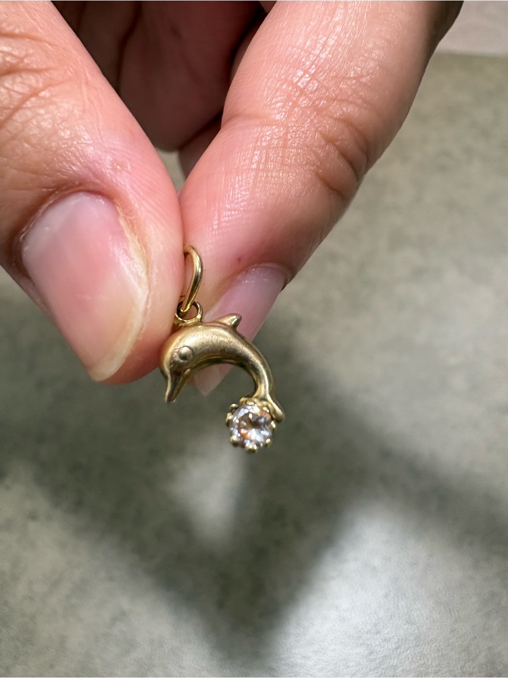 Tiny 10k gold dolphin pendant